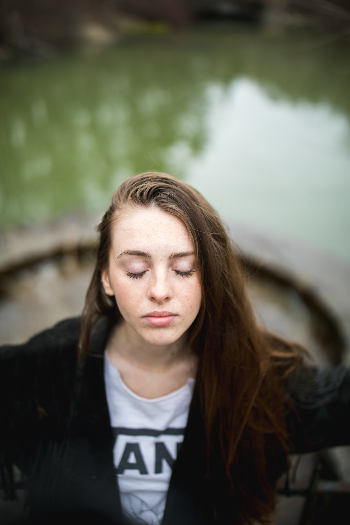 woman standing on top of bridge deep in thought