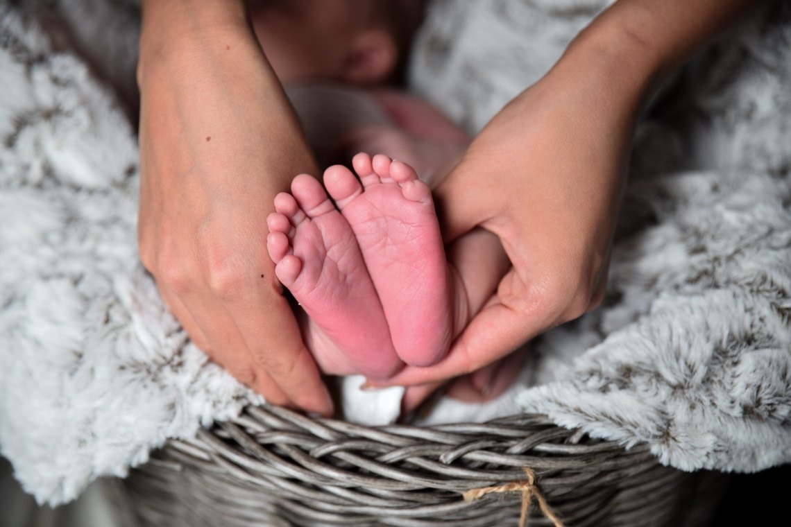 baby feet and parent hands