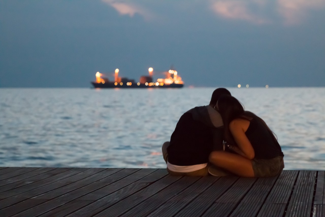 couple sitting together on dock