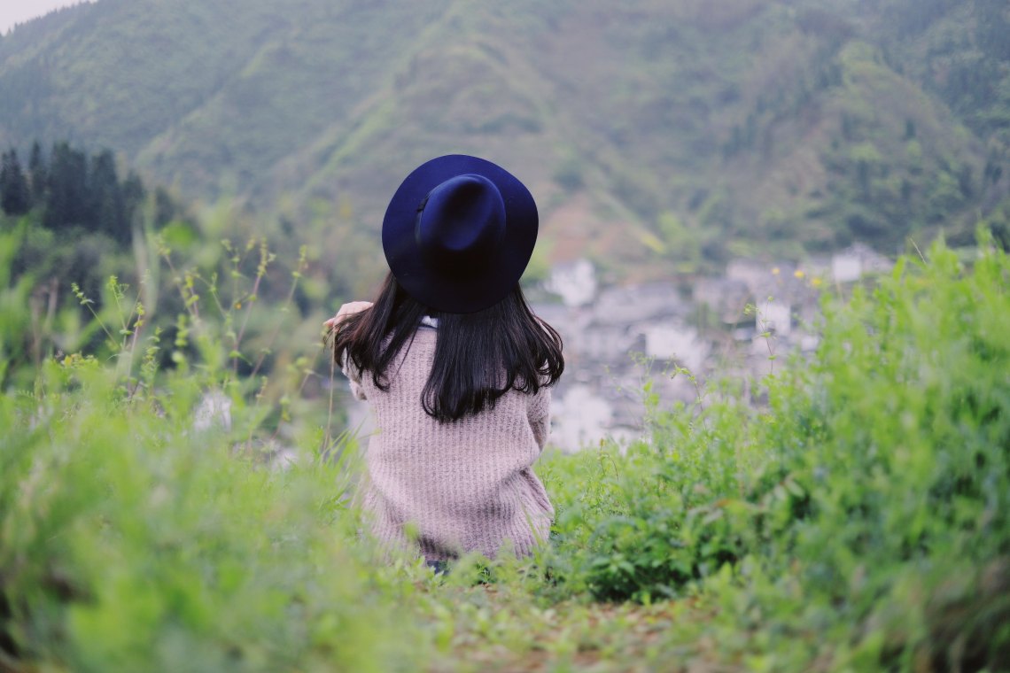 woman sitting on hill