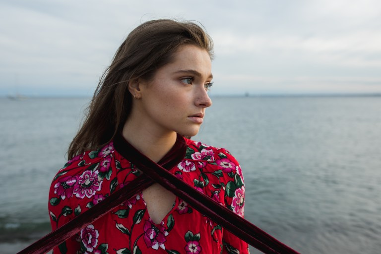 woman standing on beach deep in thought