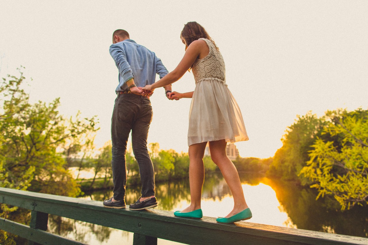 couple walking on ledge