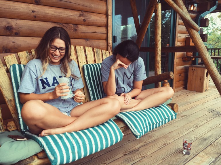 sisters laughing on porch