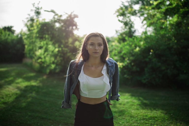 woman standing in trees