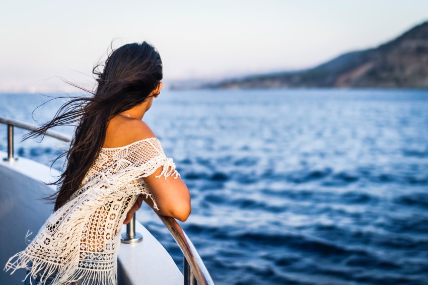 A woman stares out at the ocean, forever alone