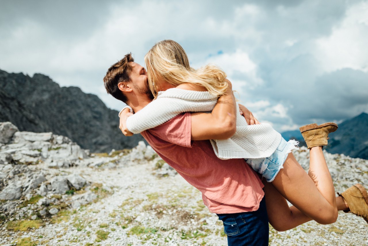 A couple kissing outside