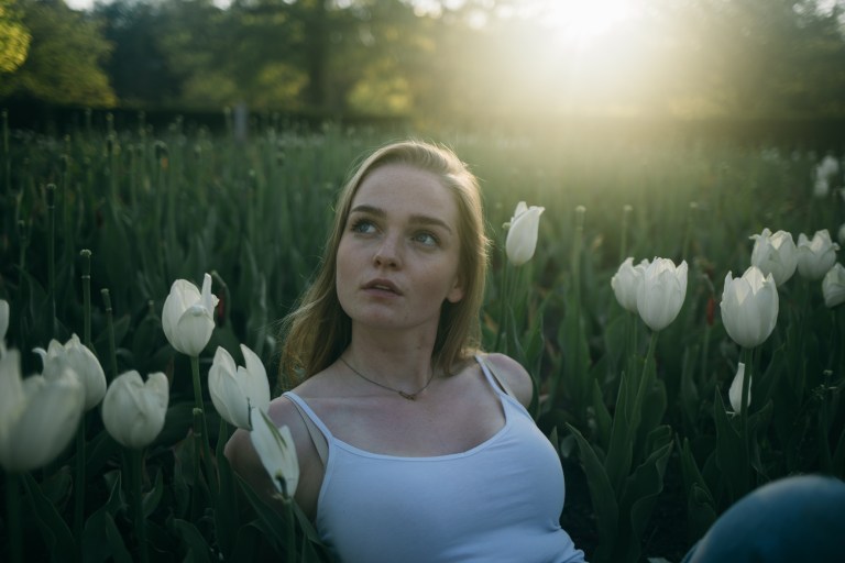 woman looking hopeful in tulips