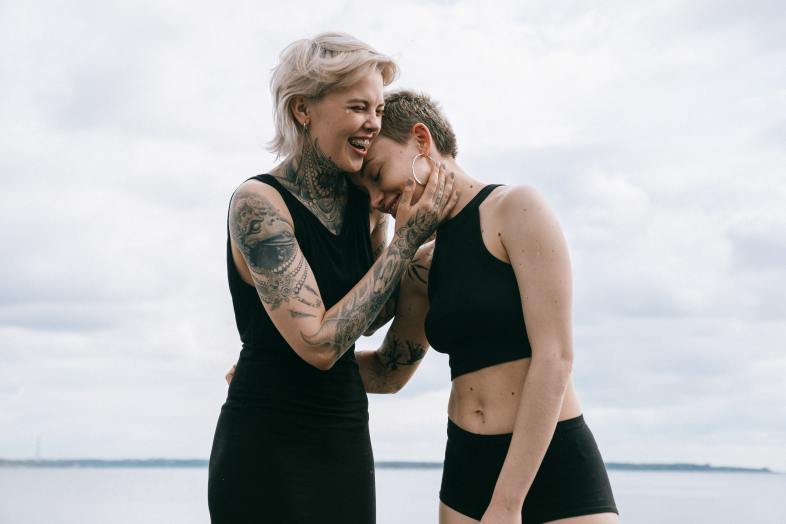 women laughing on beach