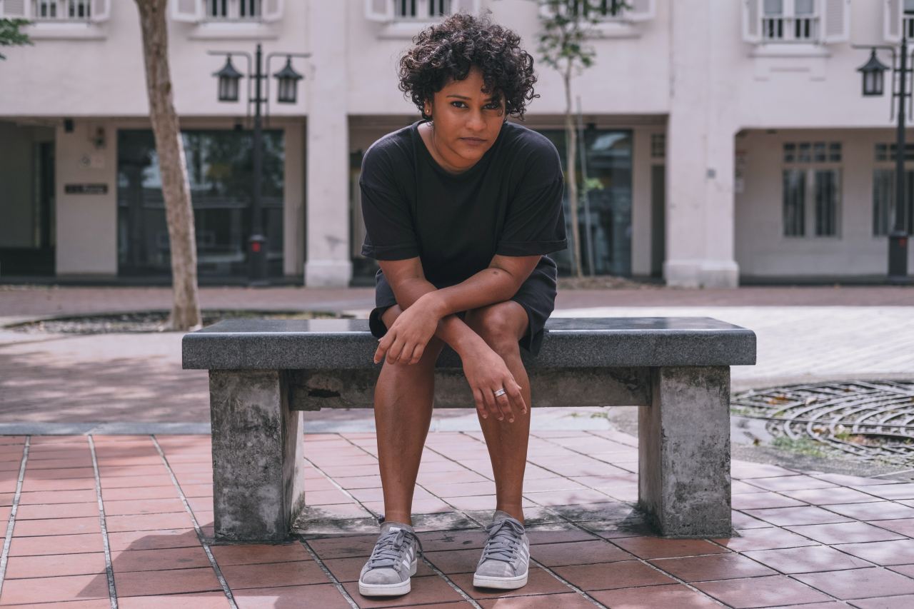 woman sitting on black marble tiled bench