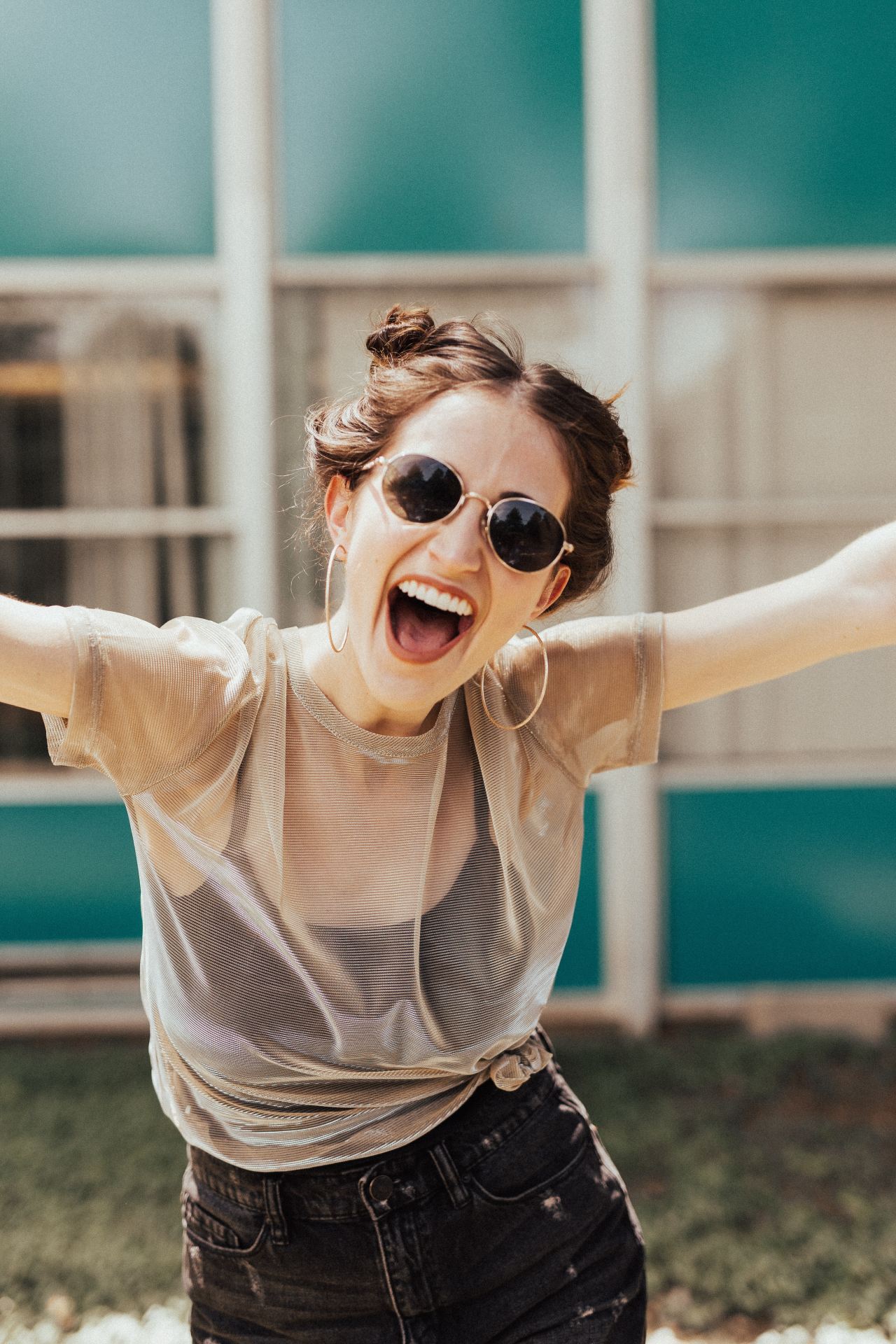 smiling woman raising hands