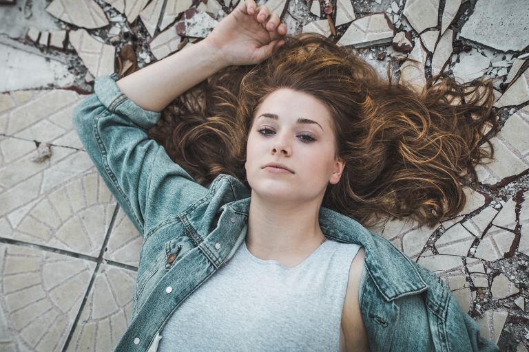 woman laying on crack tiles