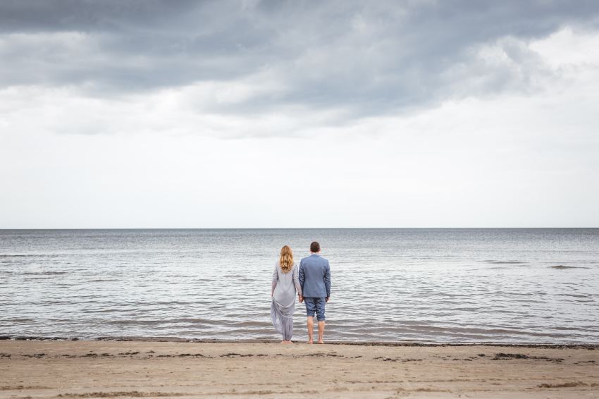 man and woman standing on shore