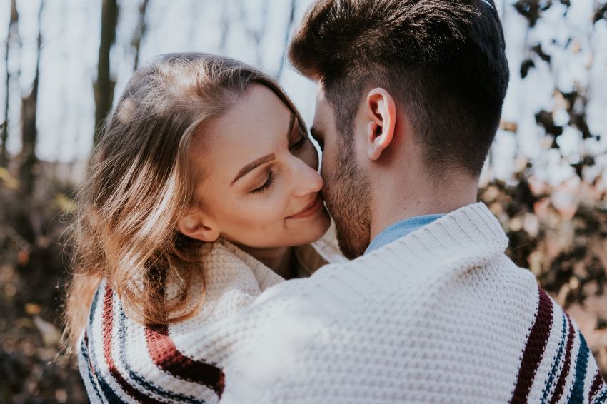 man and woman kissing during daytime