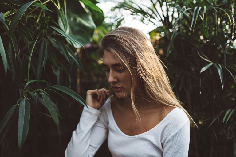 woman near green leafed plants