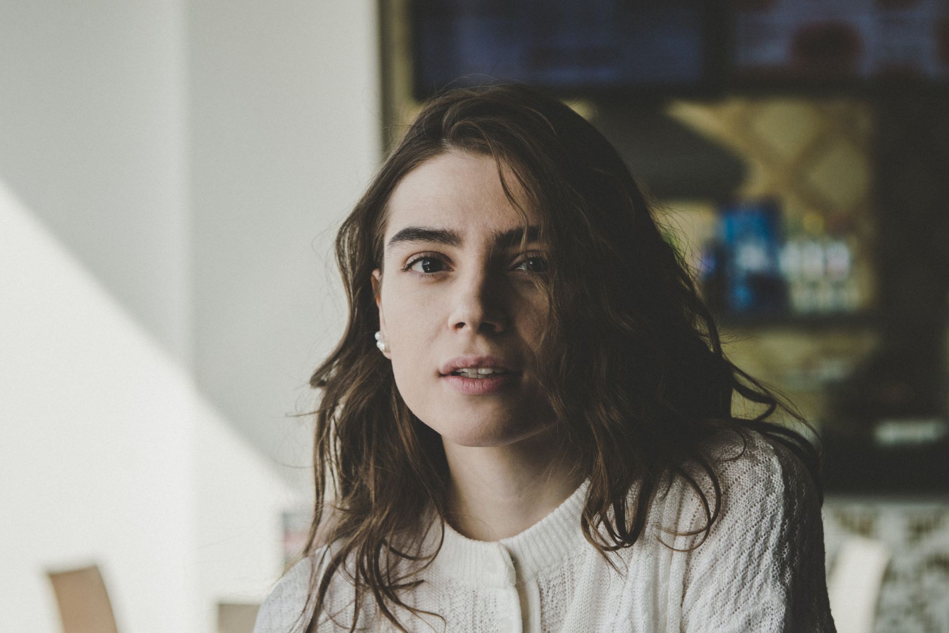 portrait photography of woman wearing knitted top