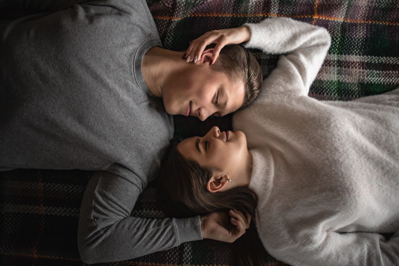 man and woman lying on bed