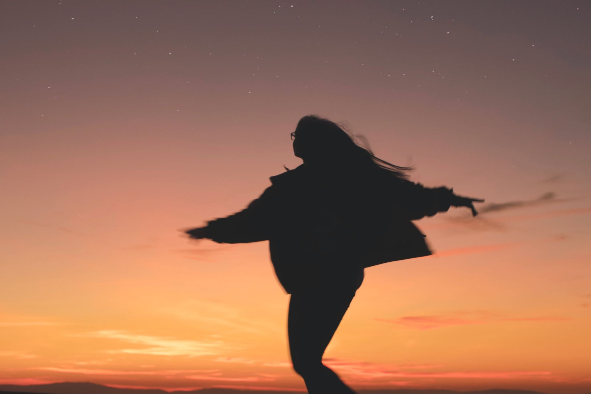 silhouette of woman running during golden hour