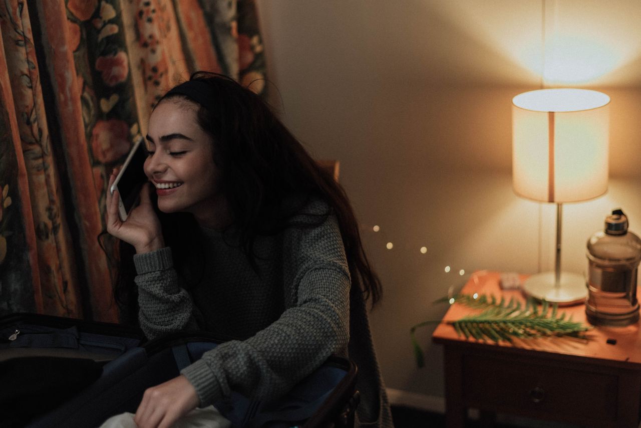 woman using smartphone in white painted room