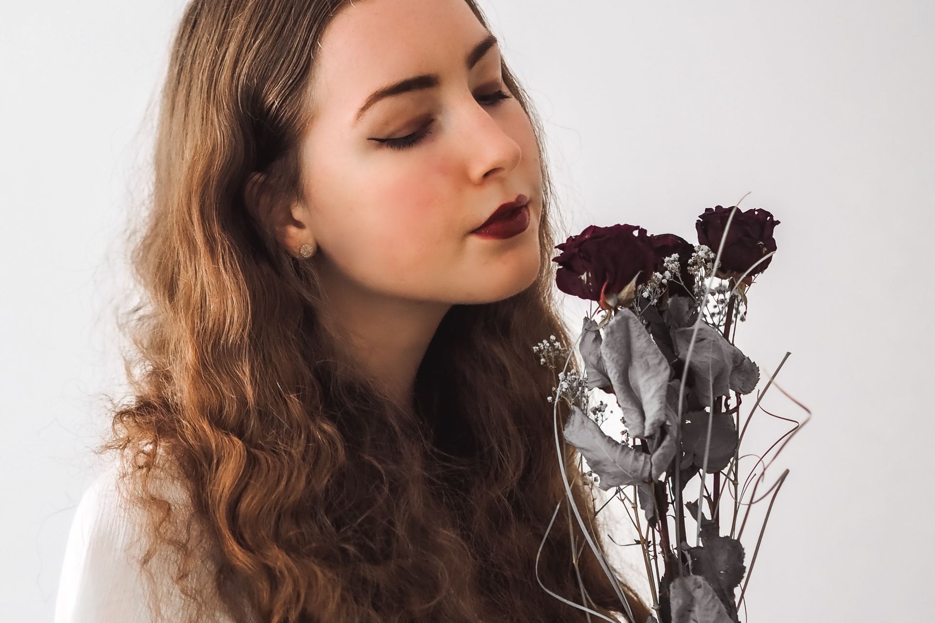 woman in white shirt with silver flower headband