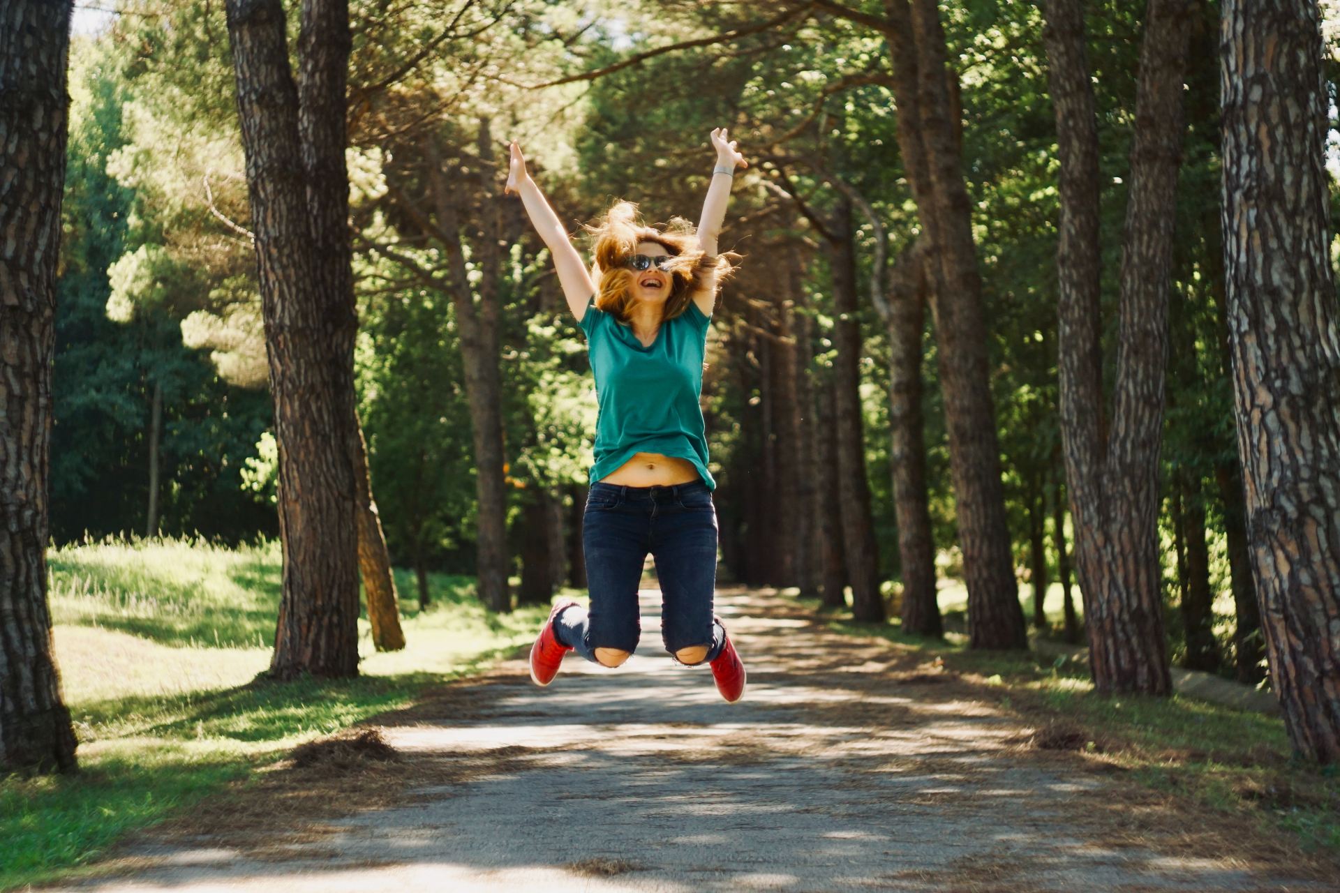 woman taking jump selfie