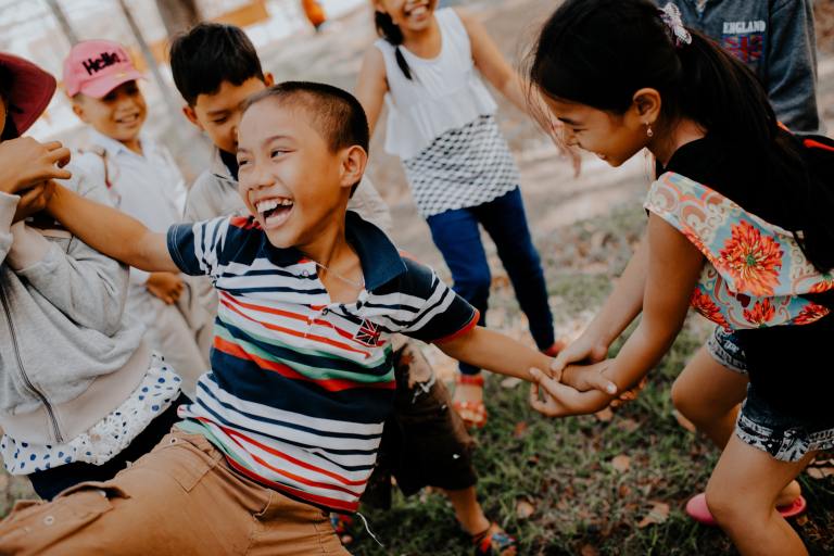 children playing on grass field photo