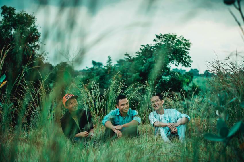 Photo of Men Sitting on Grass