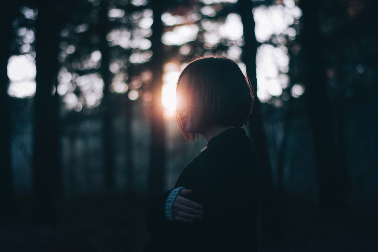 woman in black cardigan near trees