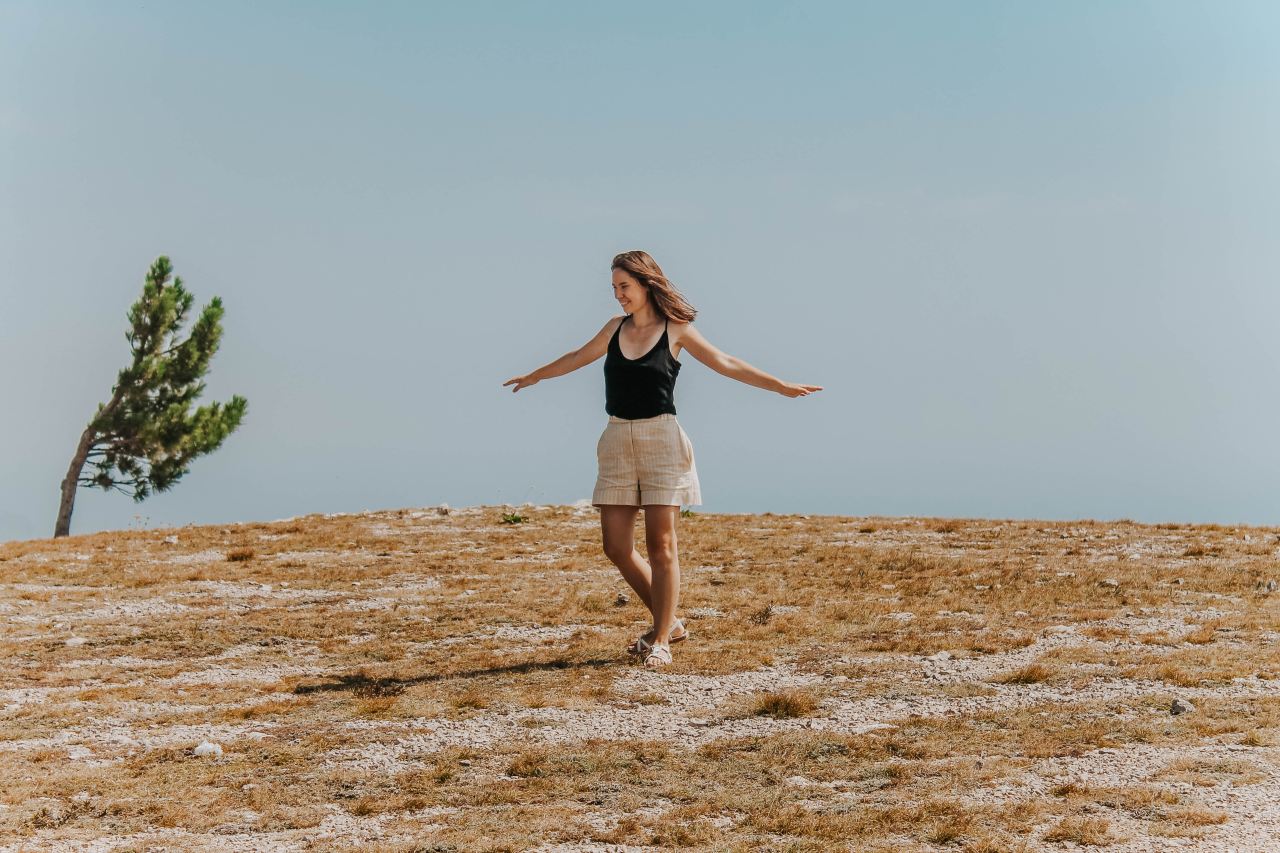 woman standing wearing black tank top during daytime