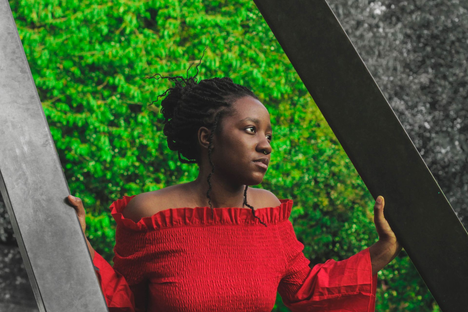 woman in red off-shoulder long-sleeved top holding posts