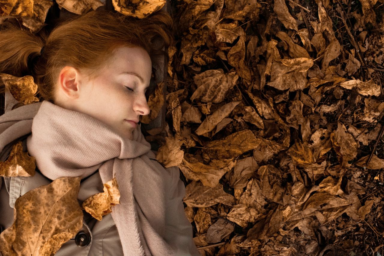 woman lying on leaves