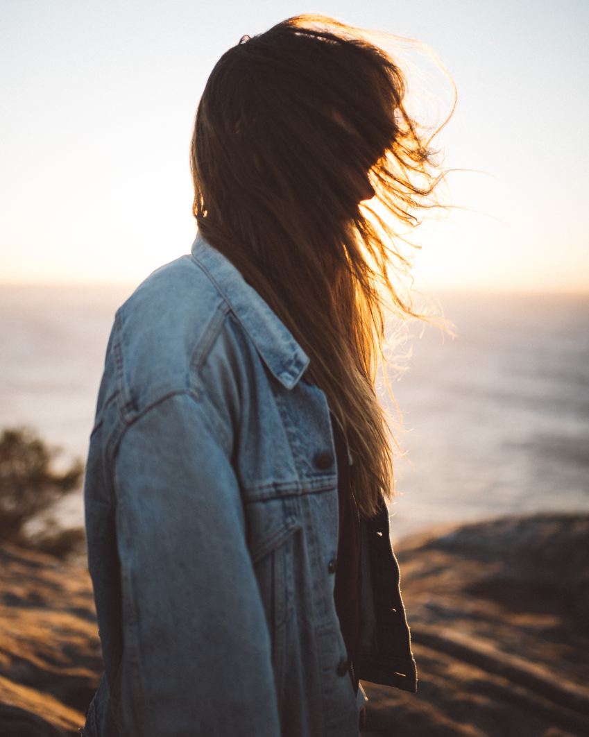 woman wearing blue button-up denim jacket