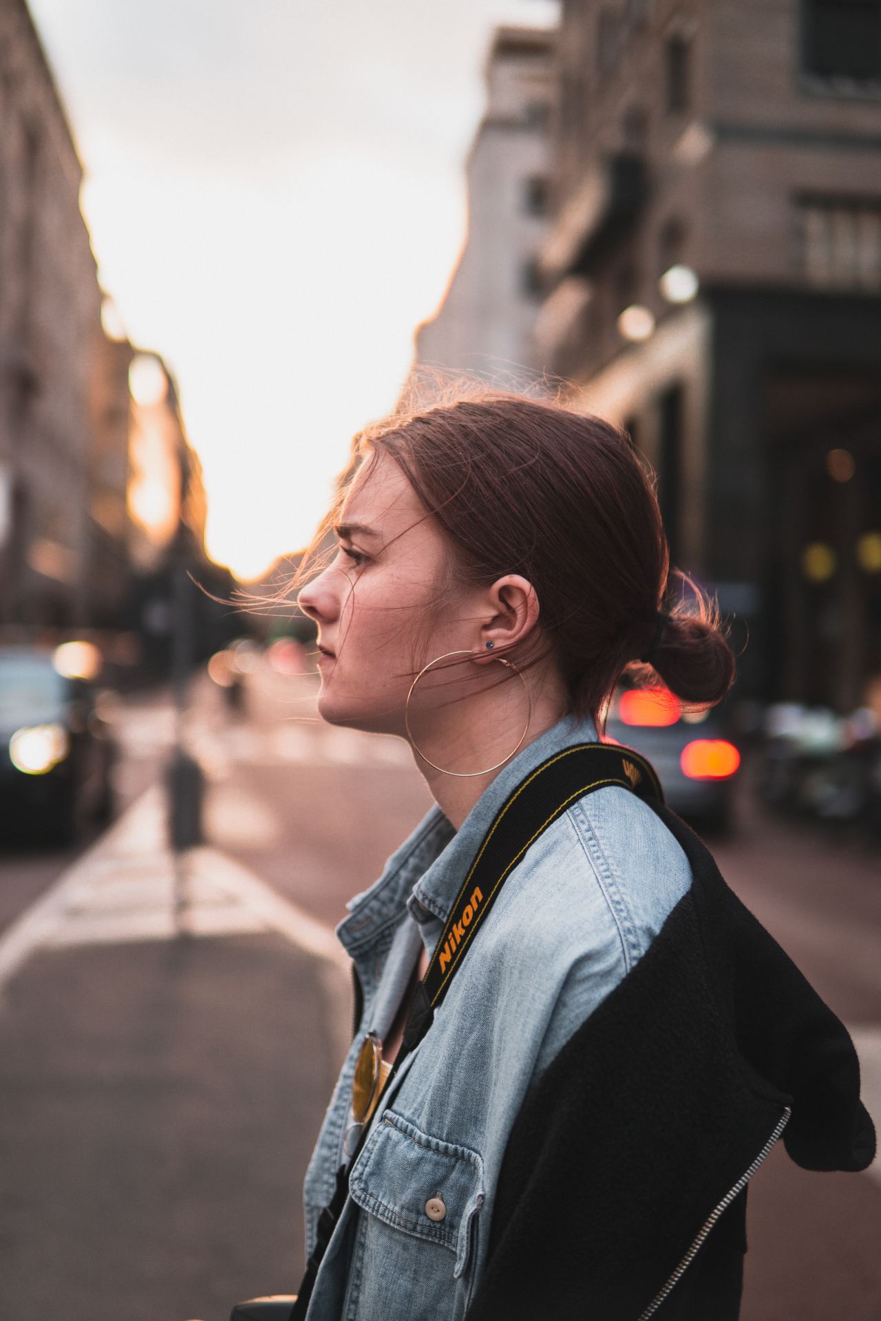 selective focus photography of woman wearing blue dress standing in road