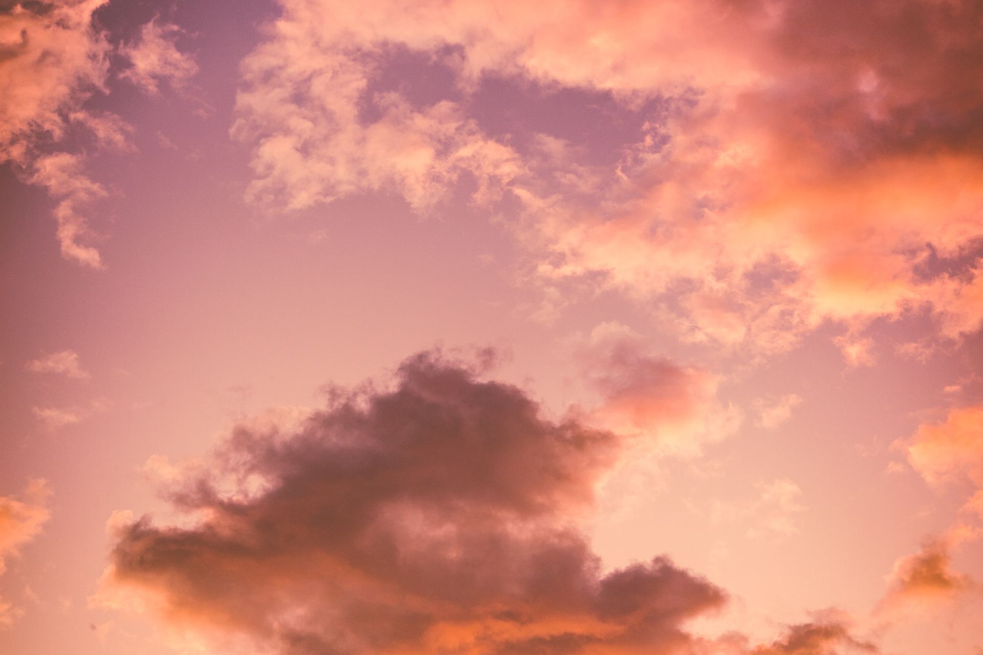 photo of cumulus clouds during golden hour