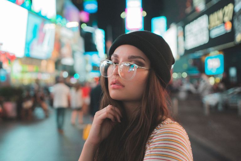 woman standing between buildings