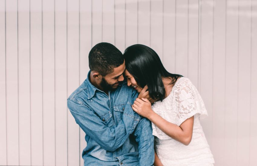 man and woman with white and gray pinstriped background