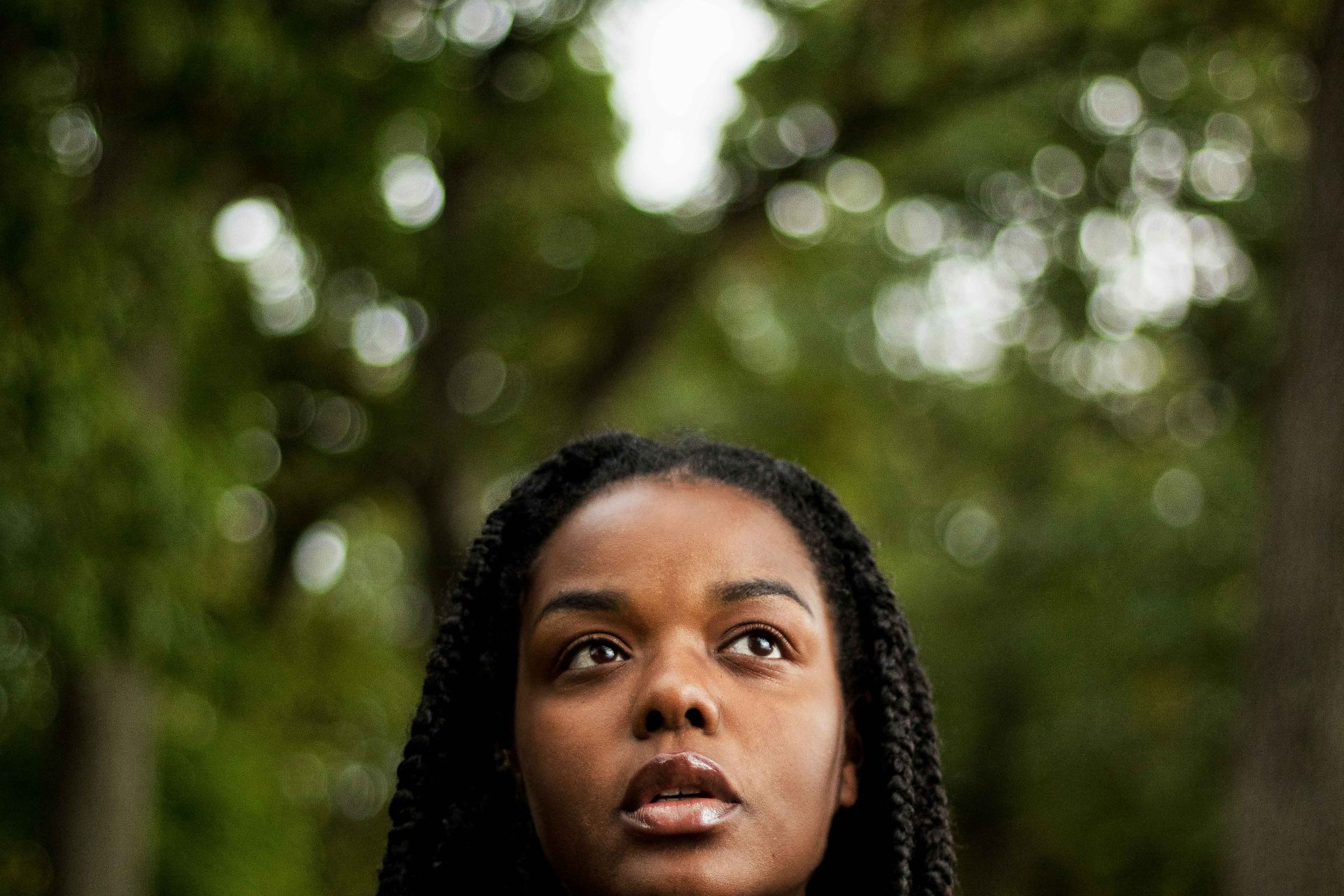 woman standing under tree