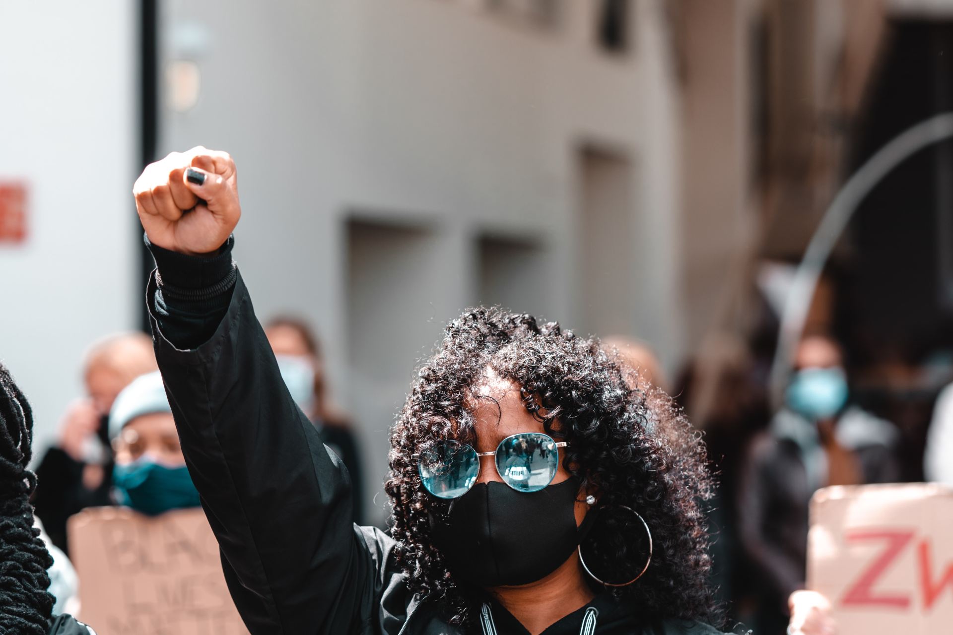 woman in black jacket wearing black sunglasses