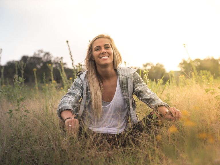 woman sitting on grass field