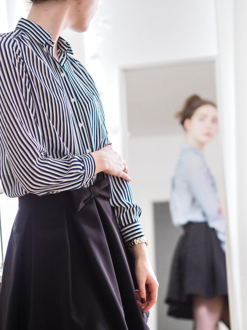 woman in black and white stripe long sleeve dress