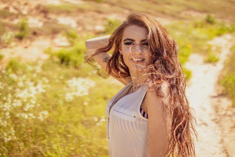 woman standing near grass field during daytime