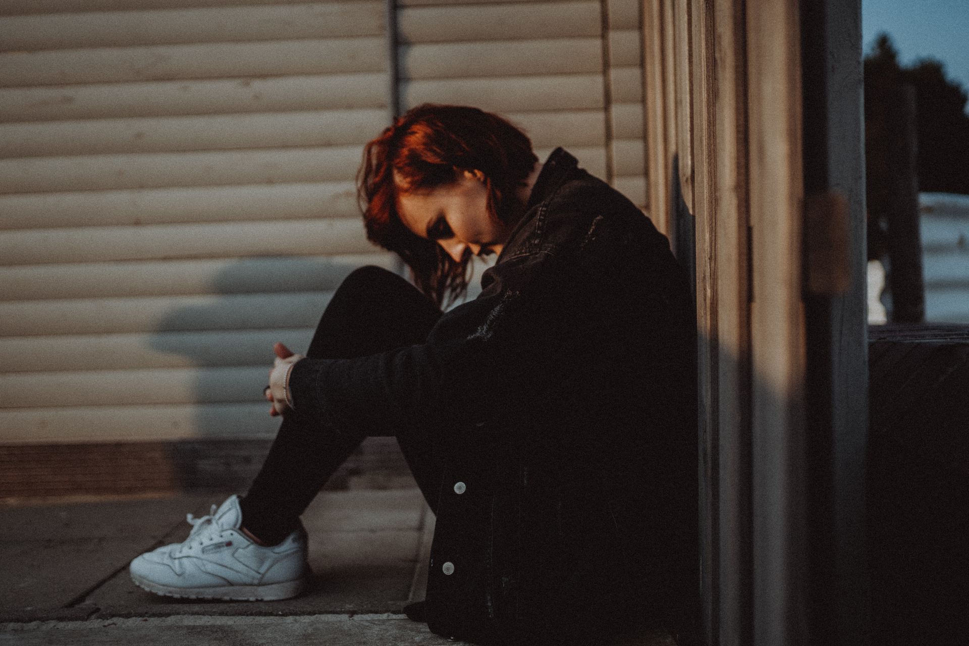 woman sitting on wall