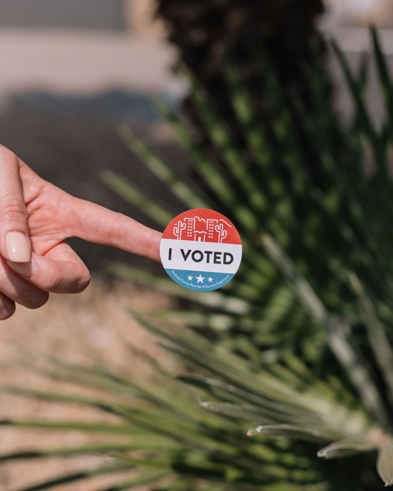 person holding red and white round pin