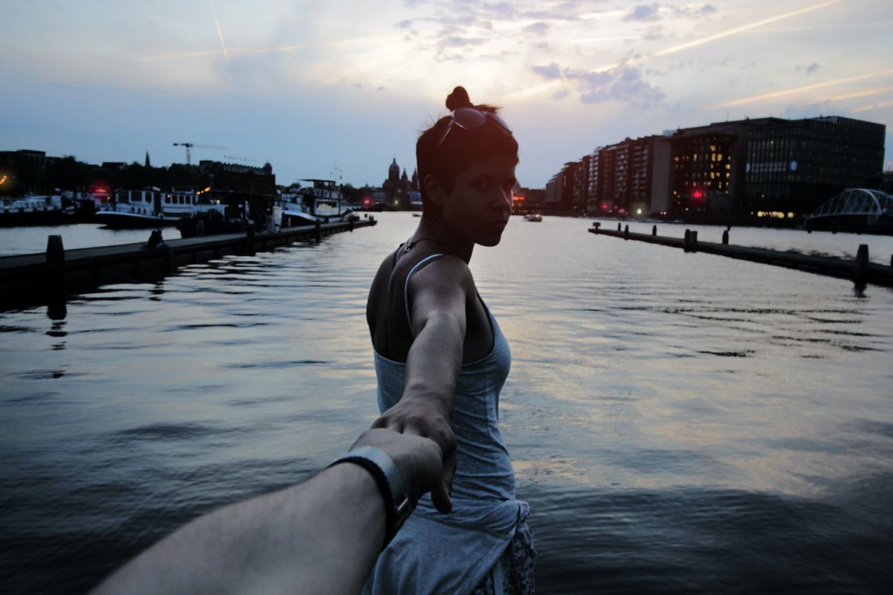 woman holding person hand taking selfie