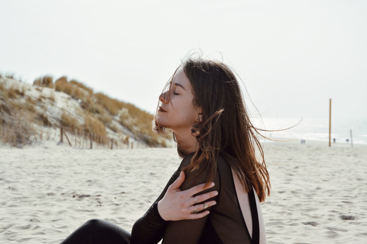 woman sitting on white sand