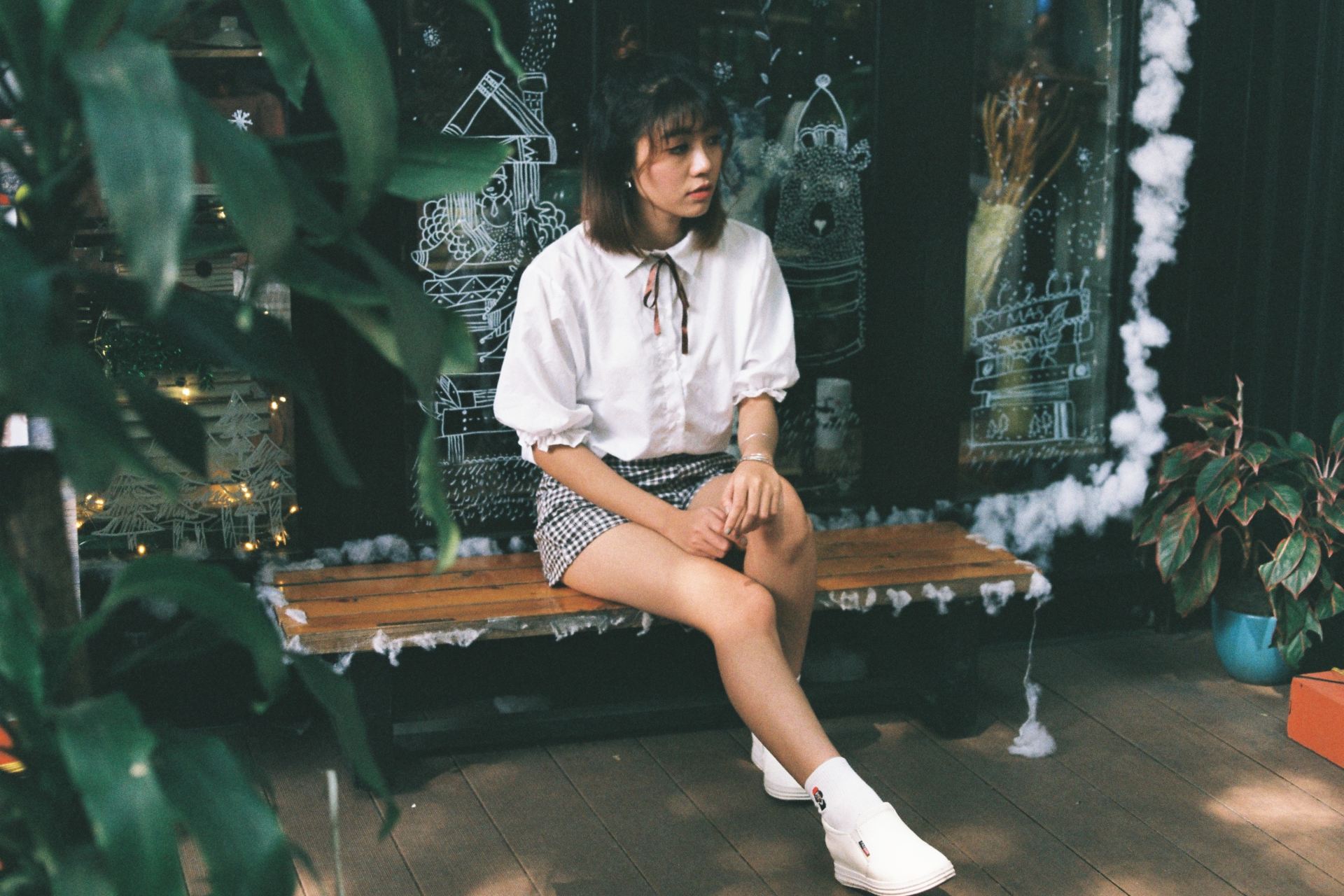 woman sitting on brown wooden bench