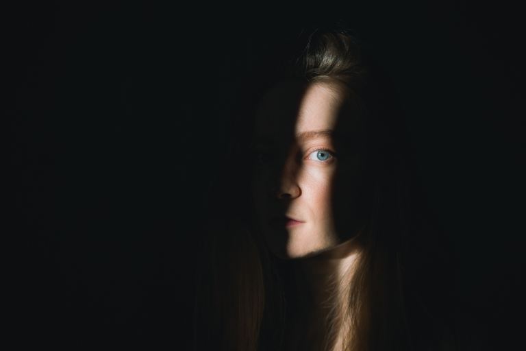 woman with brown hair looking up