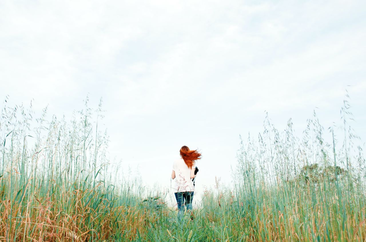 woman standing on green grass field during daytime