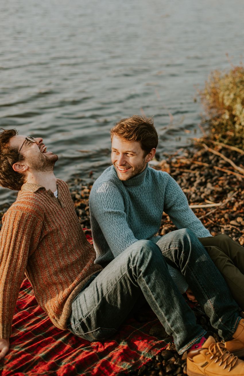 man in blue sweater sitting beside woman in red sweater