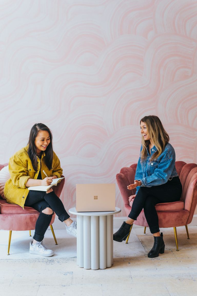 3 women sitting on chair