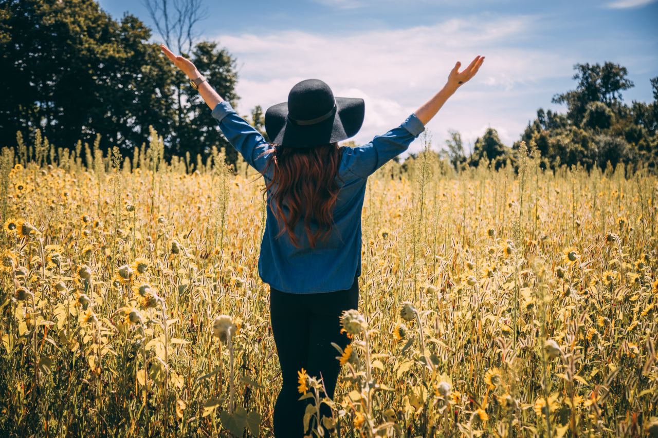 woman raising both hands